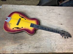 lot 135 image: 1960s Emenee Tiger Sunburst Plastic Toy Guitar