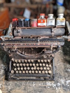 lot 131 image: Antique Underwood Typewriter with Glass Bottles