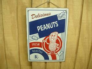 lot 54 image: Vintage Delicious Peanuts Tin Sign