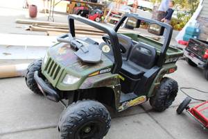 lot 58 image: Artic Cat Battery-Operated Childrens Rider Car with Monster Traction