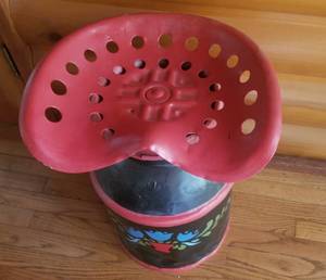 lot 209 image: Old Farmhouse Milk Can with Tractor Seat  Painted Black with Red