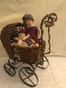 lot 32 image: Boy and Girl Twins in a Buggy