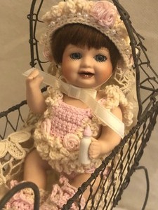 lot 28 image: Pauline Tiny Porcelain Doll with a Buggy
