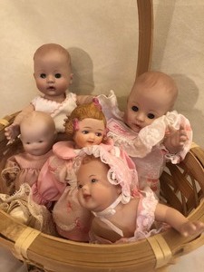 lot 57 image: Basket of Five Porcelain Babies