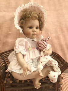 lot 129 image: Ashton-Drake Porcelain Doll in a Pink Dress