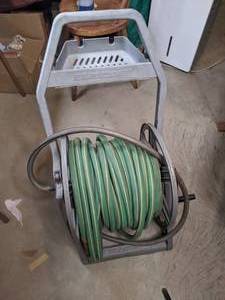 lot 112 image: Garden Hose and Plastic Reel Cart