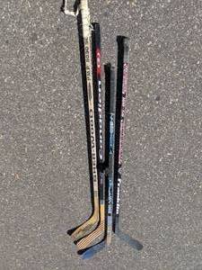 lot 217 image: Four Hockey Sticks and Puck