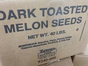 lot 229 image: 40 lb. Box Dark Roasted Melon Seeds...