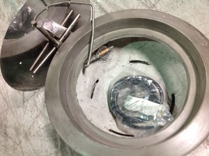 lot 116 image: Belvedere 29 in. x 12 in. Round Concrete Liquid Propane Fire Pit in Pewter with 54 lbs. Bag of 0.75 in. Black Lava Rock  in good condition