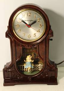 lot 25 image: Mastercrafters Swinging Girl Clock