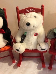 lot 42 image: Four Coca-Cola Rocking Chairs with Cuddly Friends