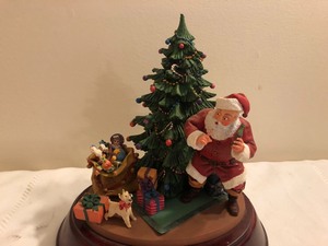 lot 86 image: A Surprise for Santa Musical Statue on a Wood Base