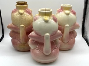 lot 49 image: Three Anamorphic Vintage Hull Syrup Pitchers