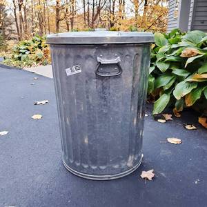 lot 202 image: Two Rubbermaid Roughneck Heavy Duty Garbage Cans and One Metal Garbage Can