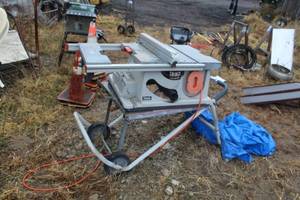 lot 1061 image: Ridgid Table Saw with Rolling Stand TS2400 0