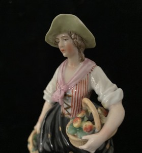 Two Porcelain Figures with Baskets of Flowers