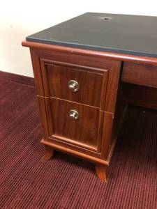 lot 3 image: BLACK LAMINATE TOP MAHOGANY COLORED EXECUTIVE DESK WITH 2 DRAWERS, CENTER DRAWER & 1 DOOR CABINET - MATCHES LOT 4 & 5