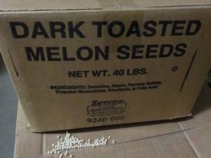 lot 242 image: 40 lb. Box Dark Toasted Melon Seeds...