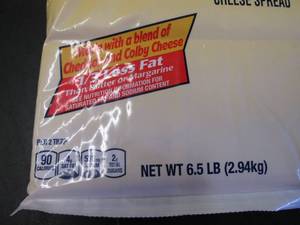lot 335 image: 6.5 lb bag Kraft Cheez Whiz needs no refrigeration till opened.  Dated 4-1 2021