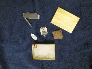 Carved rock, golf cuff link, knife,...