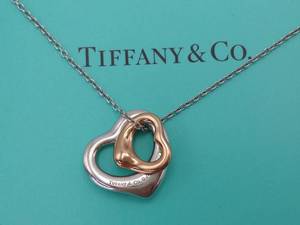 lot 36 image: Tiffany & Co 18k and Sterling Silver Dancing Hearts Estate Necklace $1650 Retail