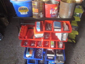 Roller parts cabinet with red bins,...
