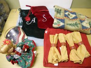 lot 54 image: Flannel throw, Christmas Doll - Musical, Stockings, Placemats, Napkins, and Napkin Rings