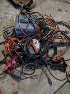lot 80 image: Jumper Cables, 24 Volt Battery Charger and Assorted Electrical Cords