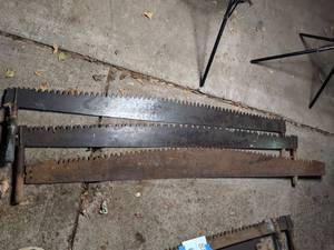 lot 92 image: (2) Vintage Two-Man Saws and (1) Extra Blade