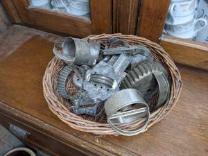 lot 45 image: Vintage Cookie Cutters in Wicker Basket