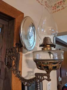 lot 439 image: Antique Hurricane Lamp Sconce with Reflector and Ornate Cast Iron Bracket