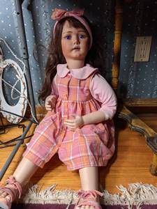 lot 339 image: Little Girl Doll with Pink and Orange Dress