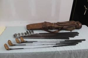 lot 33 image: Lot of (12) Ted Woolley Wood Shafted Golf Clubs with Vintage Period Leather Golf Bag - 2 Iron, 3 Iron, 4 Iron, 5 Iron, 6 Iron, 7 Iron, 8 Iron, 9 Iron, 1 Wood, 2 Wood, 3 Wood, 4 Wood