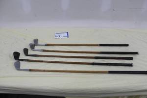 lot 80 image: Lot of (5) Vintage Wood Shafted Golf Clubs - Piccadilly Putter, Spalding 135-145yds. Symetric Set 5 Iron, Windsor 2 Mid Iron, MacGregor Mid Iron L, Hillerich and Bradsby Invincible Mid Iron