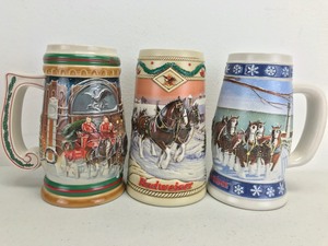 lot 7 image: Vintage Budweiser Holiday Beer Steins (Lot of 3)
