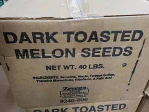 lot 213 image: 40 lb. box dark roasted melon seeds...