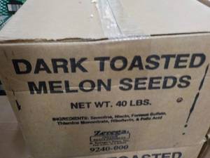 lot 214 image: 40 lb. box dark roasted melon seeds...