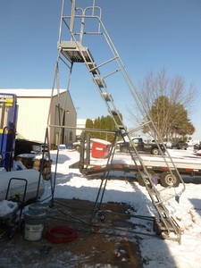 lot 7 image: 10 Cotterman rolling ladder. Has some bends & breaks in frame. Step assembly in used good condition. As shown.