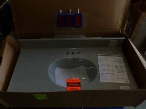 lot 8 image: Vanity top 37 x 19. Right side splashguard. Appears to be new in the box. As shown.