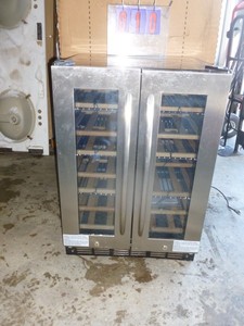 lot 10 image: Insignia wine cooler. 34 x 23 x 23. Separate controls for each side. Has minor scratches & dents. Appears new. Unable to test in cold warehouse.  As shown.