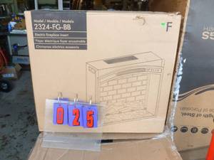 lot 25 image: Electric fireplace insert. 24 x 8 x 22 Box appears to be unopened. As shown.