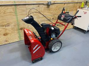 lot 1 image: TROY-BILT Storm 28 in. 243cc Two-Stage Electric Start Gas Snow Blower with Noise Guard Technology and Airless Tires