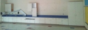 Large Bank of cabinets, Base upper, pantry includes lighting on wall & sink and countertop.