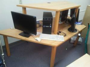 2 Computers Monitors and more on a computer table.