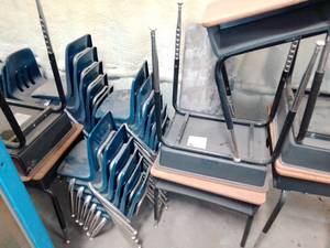 26 Plastic chairs and 7 metal desks.
