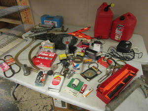 lot 218 image: ASSRTD. AUTOMOTIVE SUPPLIES, GREASE GUNS, HITCHES, TRACTION CABLES, GAS CANS, TUNE-UP KITS,  MORE