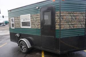 lot 1 image: 2020 Ice Castle Model 14V Custom Camo Fish House Camper Toy Hauler