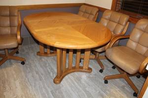 lot 163 image: Wood Dining Set - Oval Wood Dining Table, LeatherVinyl Padded Wood Rolling Arm Chairs (x4)