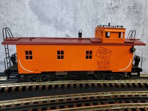 lot 28 image: K-Line 3-Rail Milwaukee Road Off  enter Cupola Simulated Woodsided Smoking Caboose. K616-1371