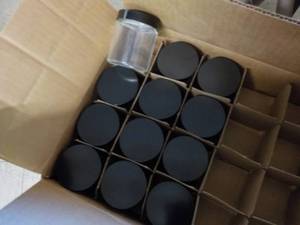 12 4 oz. glass jars with lids...
